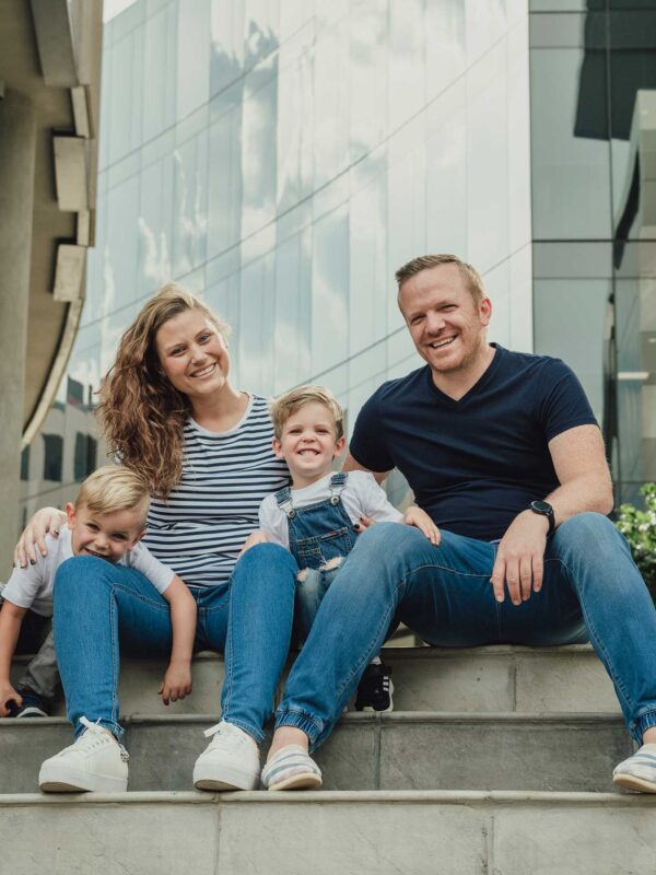 Couple with two small children sitting on steps together